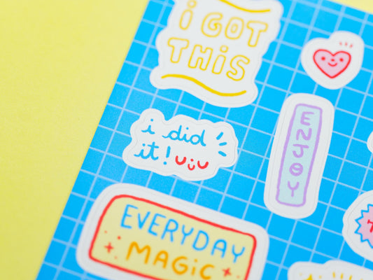 Motivational stickers on a blue grid background with a yellow border
