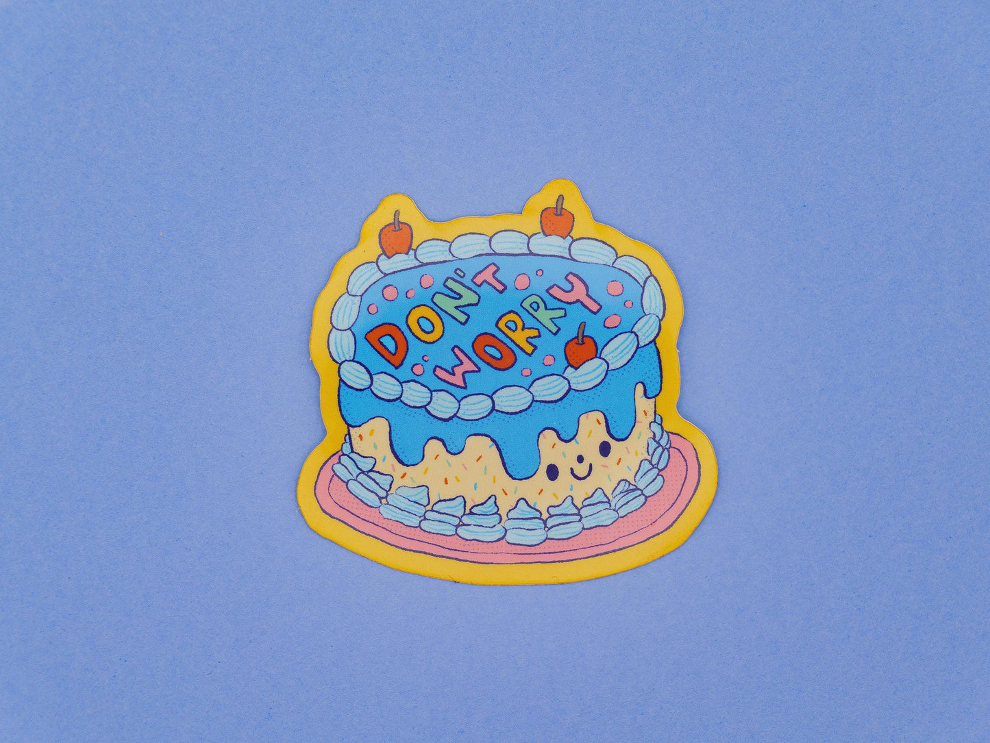 Colorful cake sticker with 'Don't Worry' text on a blue background