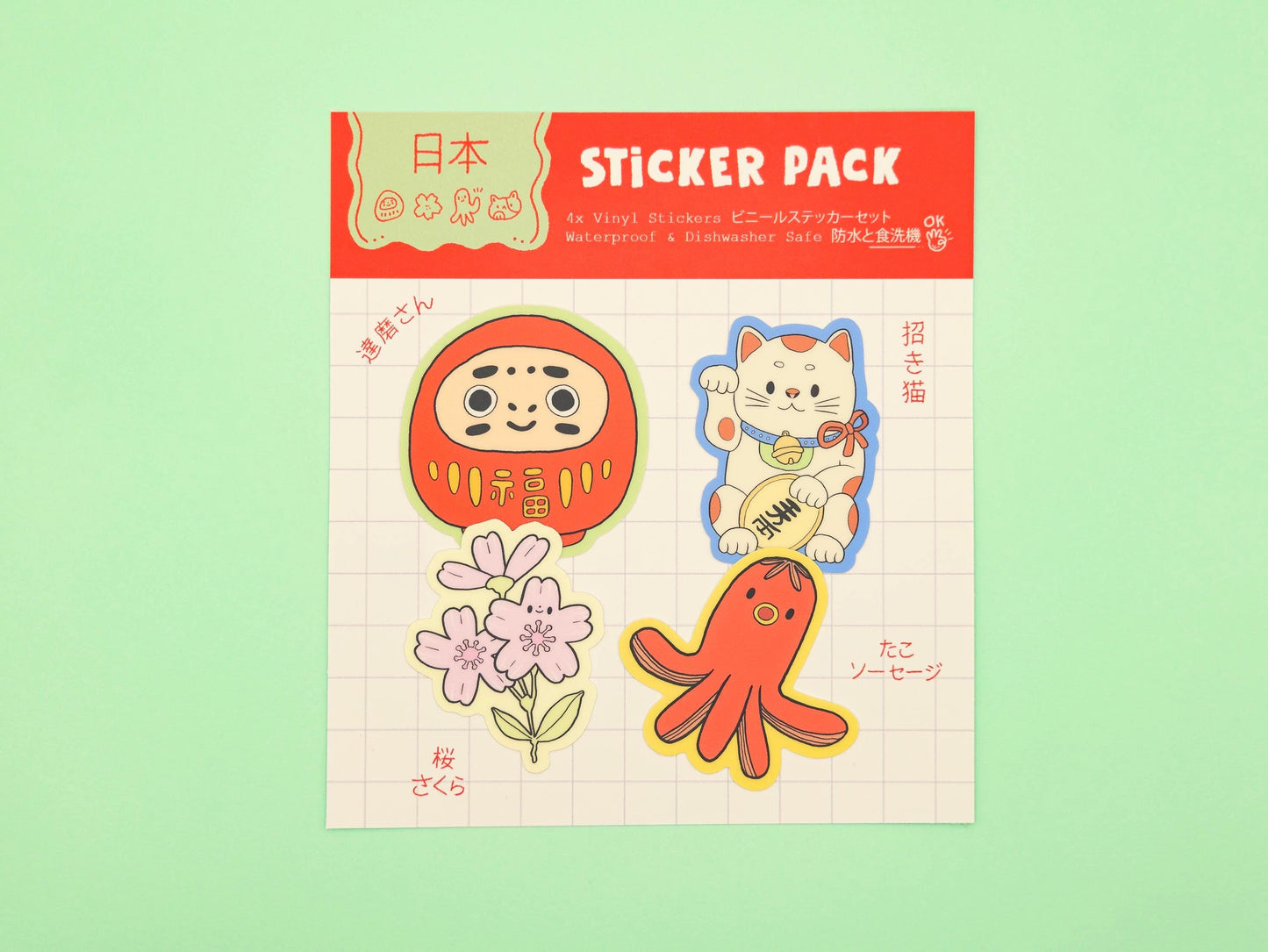 Sticker pack with cartoon characters on a green background. Daruma, Maneki-Neko, Sakura Flower and tako sausage