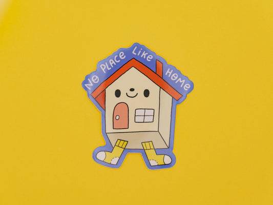 Cartoon house with 'No Place Like Home' text on a yellow background