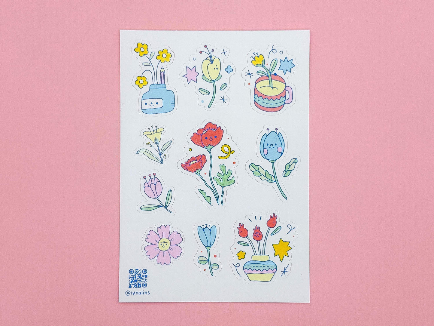 Sheet of colorful floral stickers on a pink background