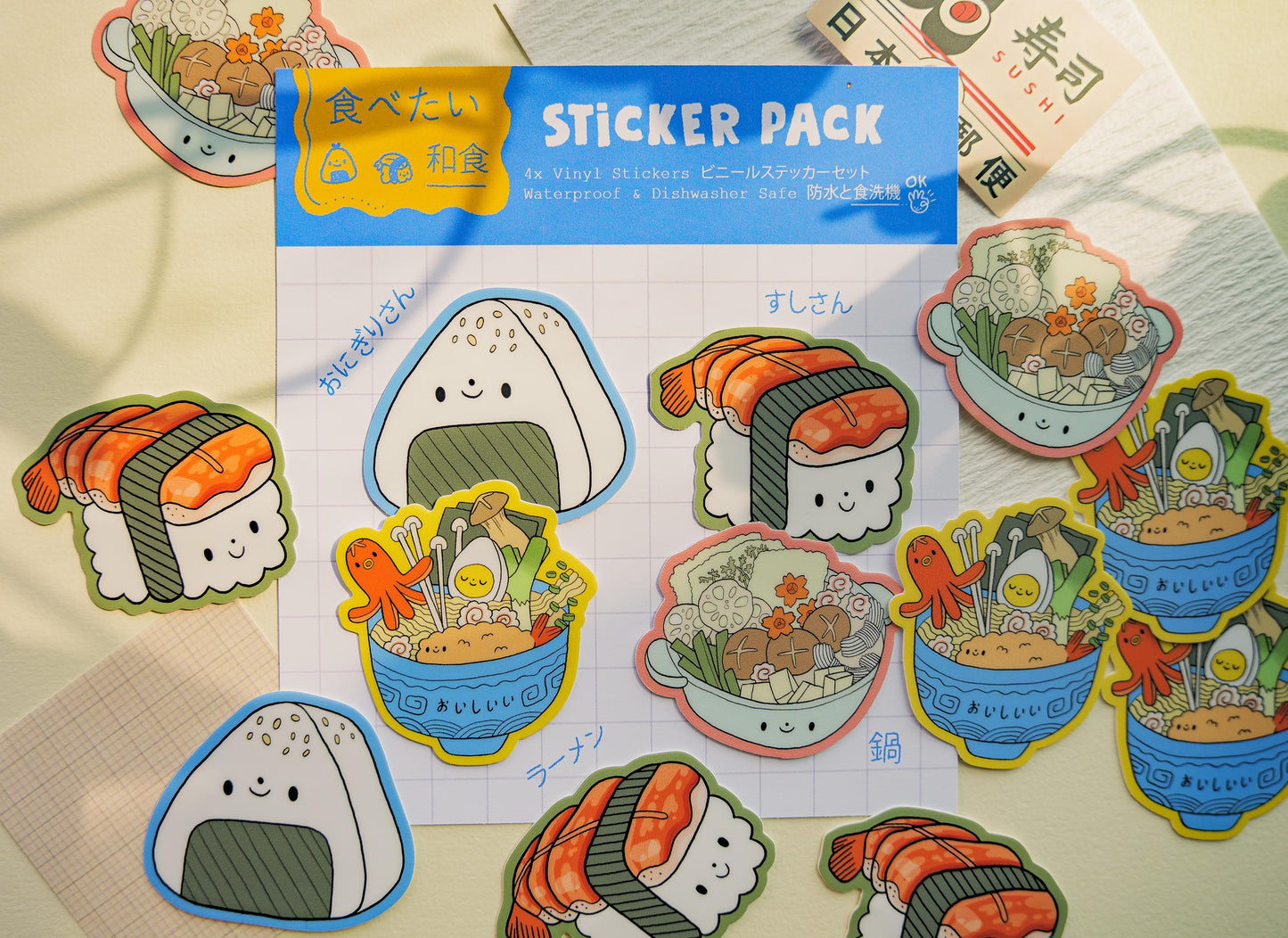 Sticker pack with cute food illustrations on a colorful background.  Onigiri rice ball, sushi, ramen and nabe.