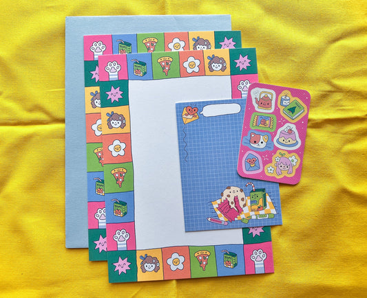 Colorful stationery set with stickers on a yellow fabric background