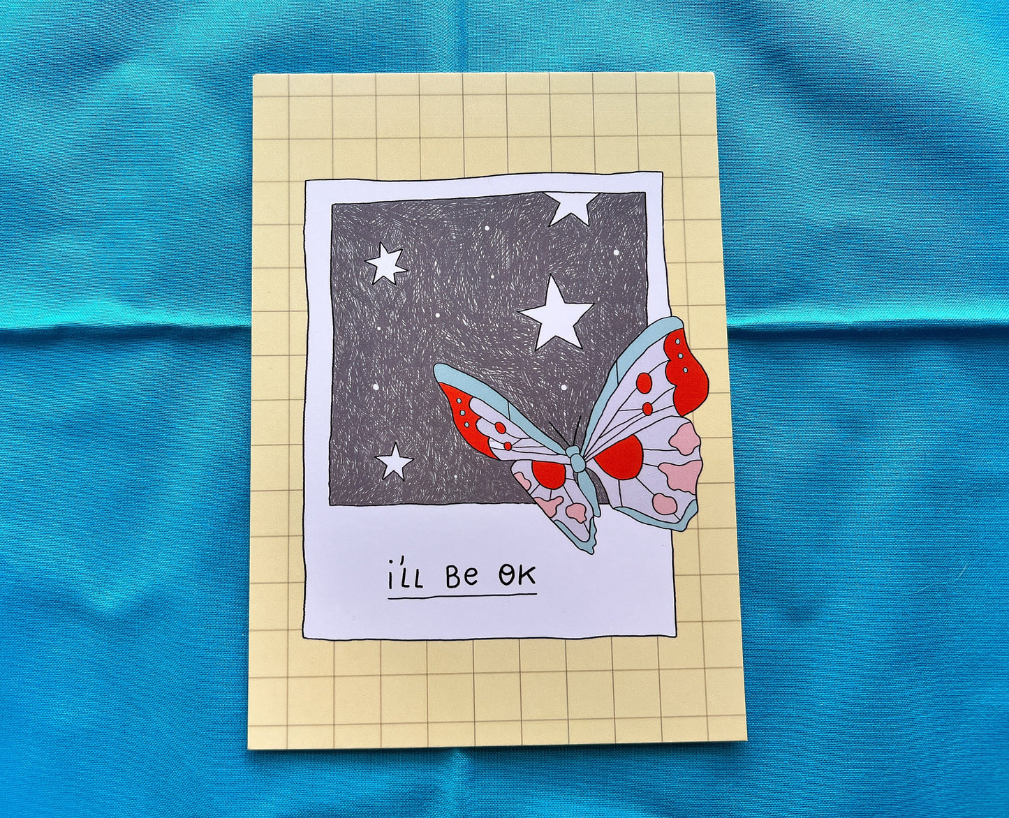 Card with a butterfly illustration and 'I'll be OK' text on a blue fabric background