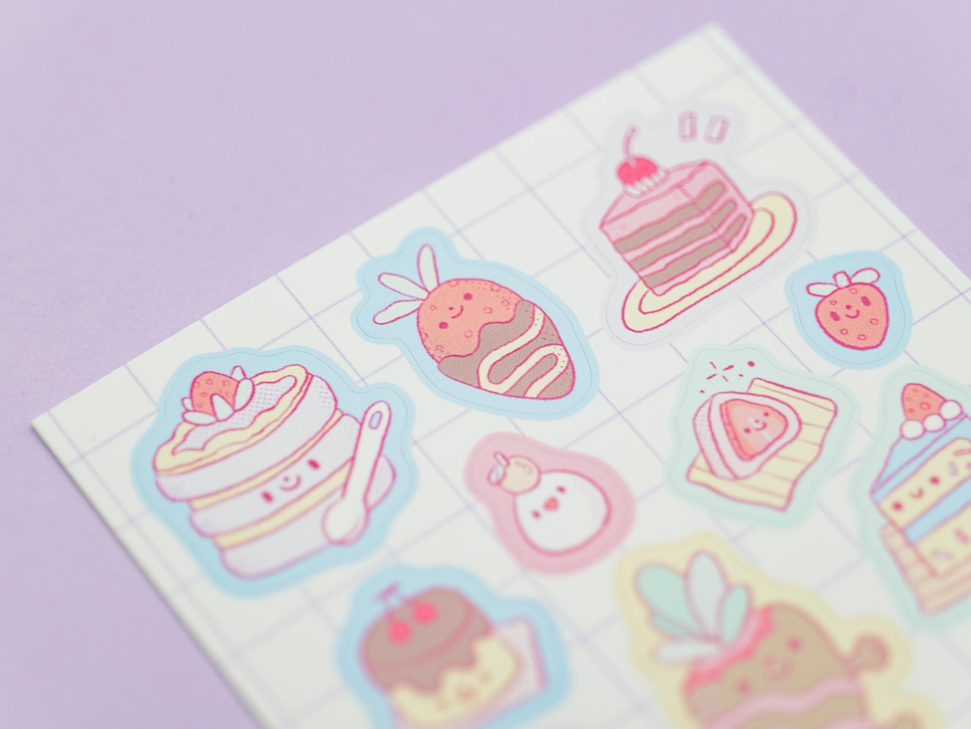 Sheet of colorful pastel stickers featuring desserts on a light purple background