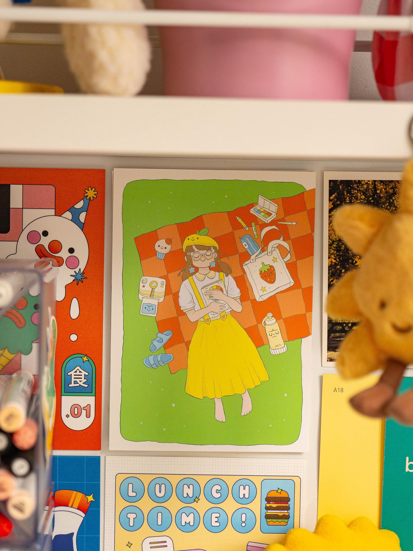 Postcard with illustrations and text on a shelf.