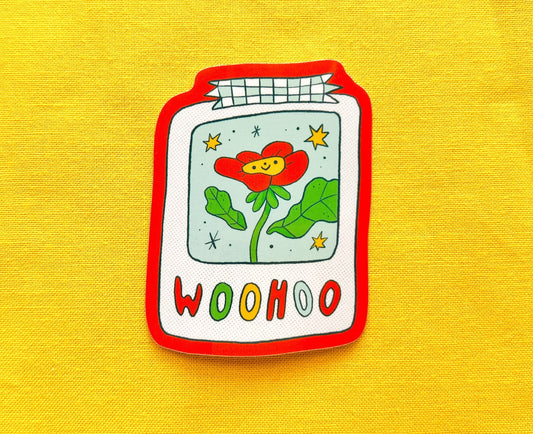 Sticker of a flower design and 'WOOHOO' text on a yellow background