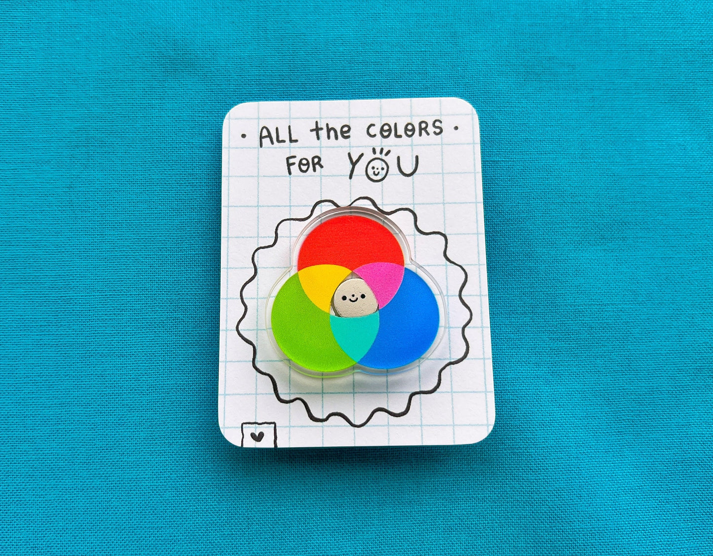 Color wheel badge on a card with 'All the colors for you' text on a blue background