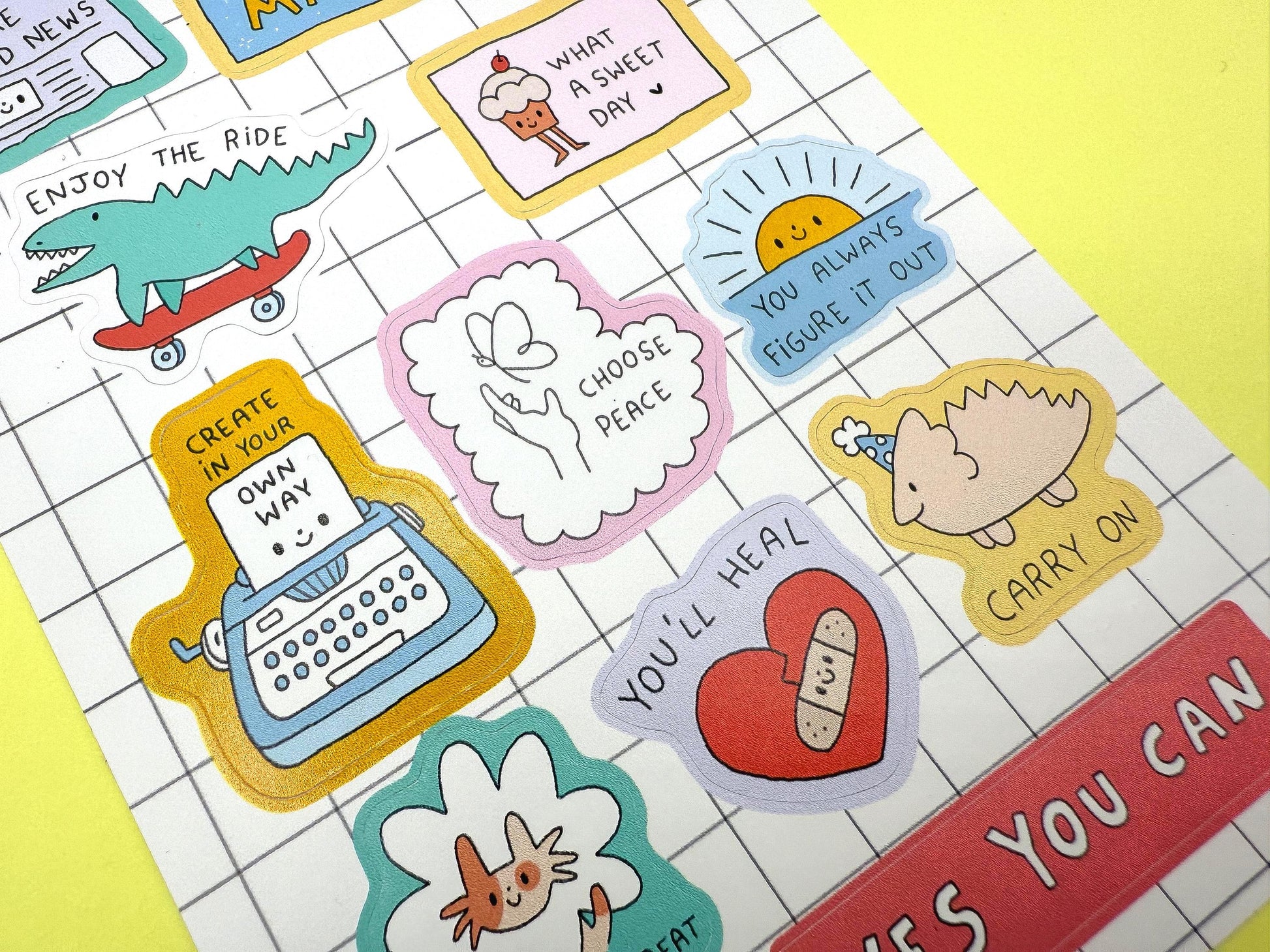 Collection of colorful stickers with various designs on a grid background