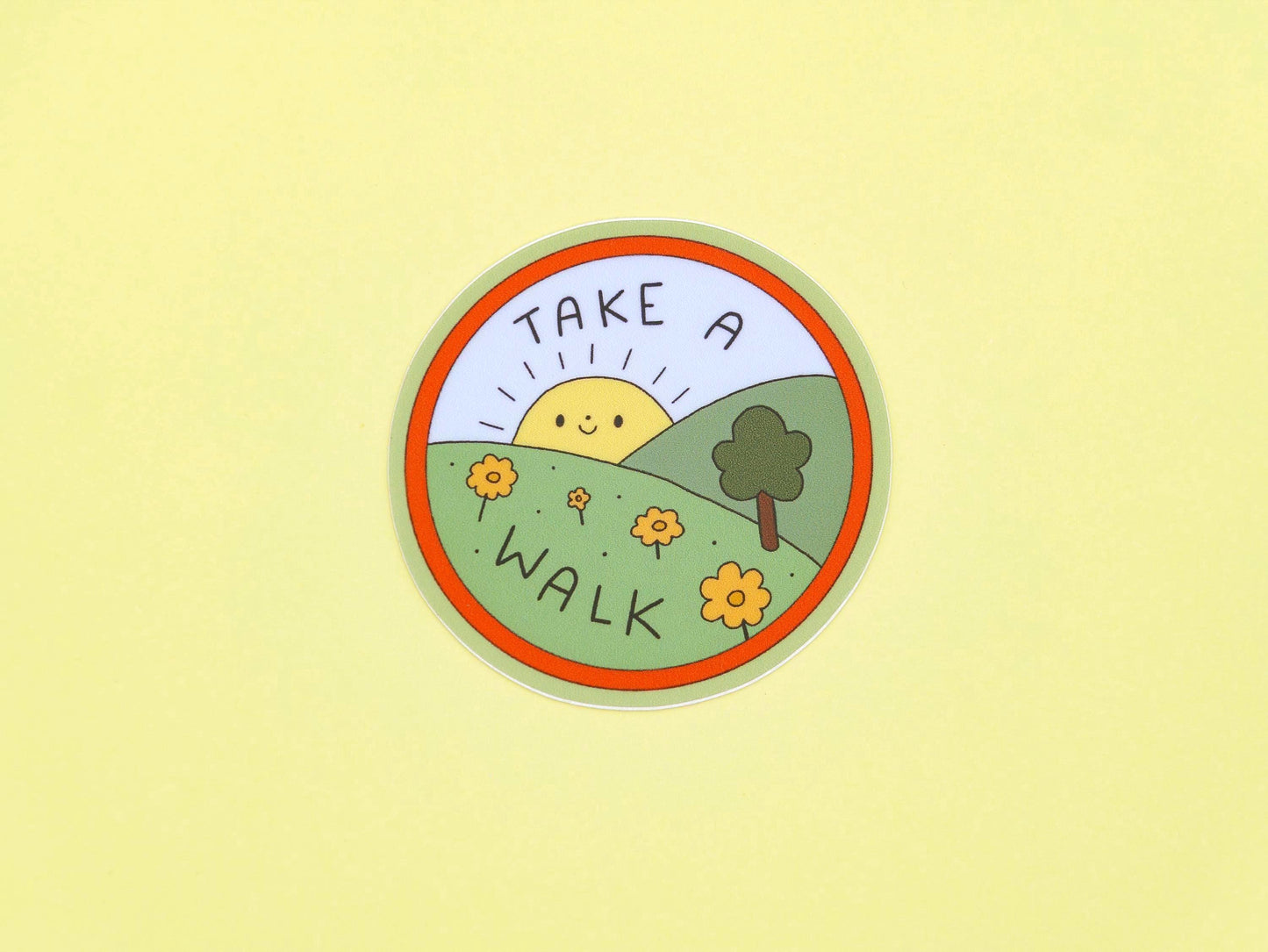 Circular sticker with 'Take a Walk' text on a yellow background
