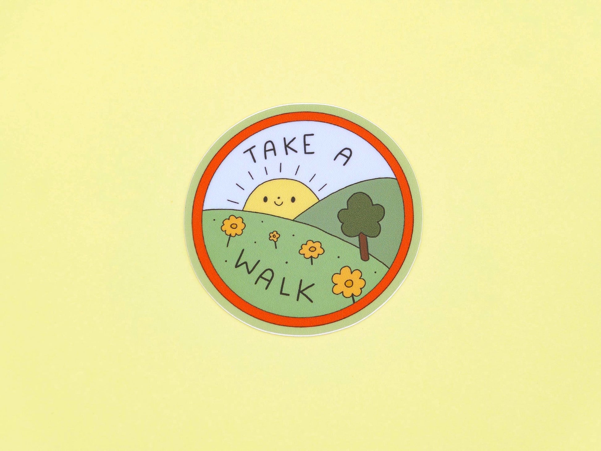 Circular sticker with 'Take a Walk' text on a yellow background